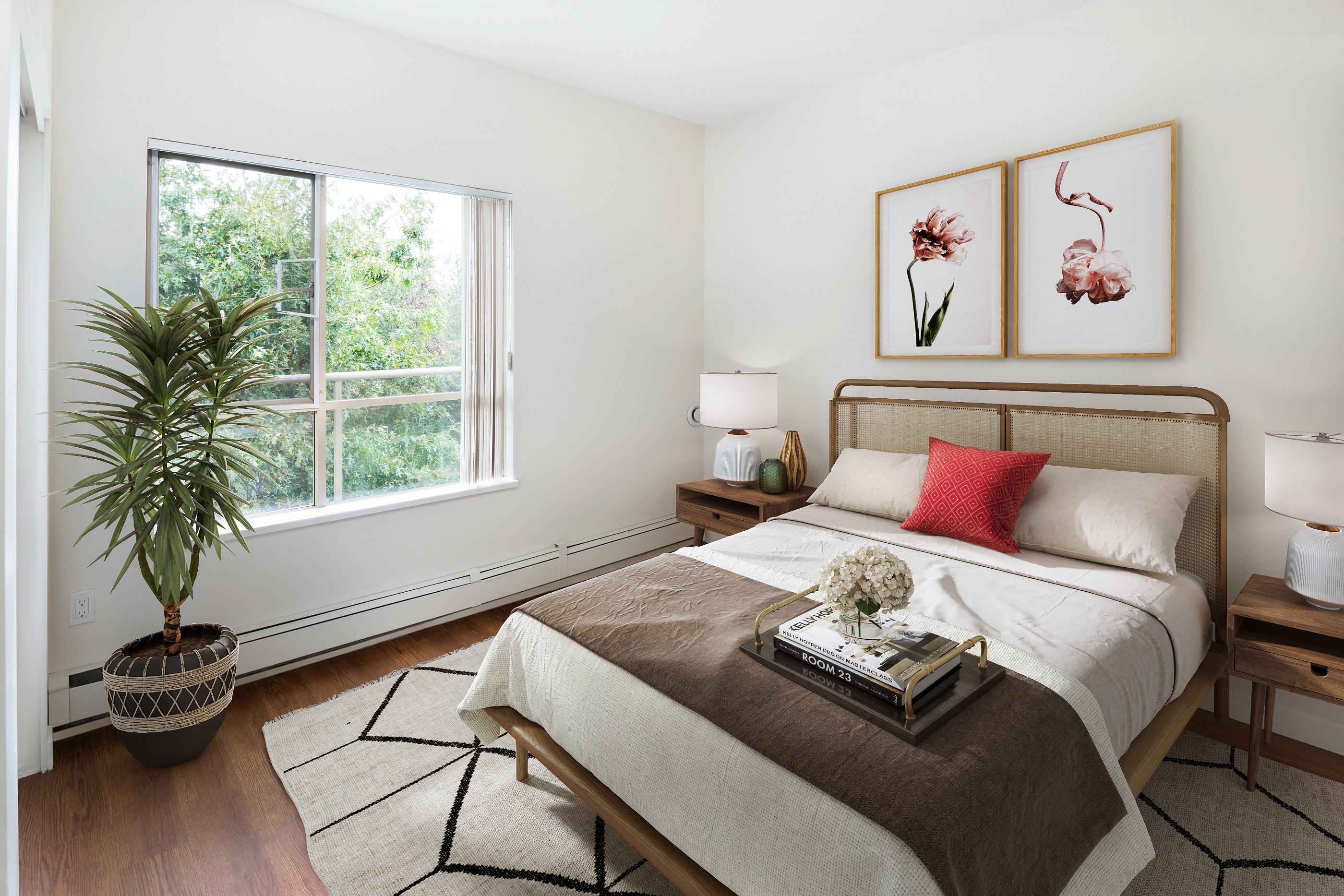 a bedroom with a bed and a potted plant and a window